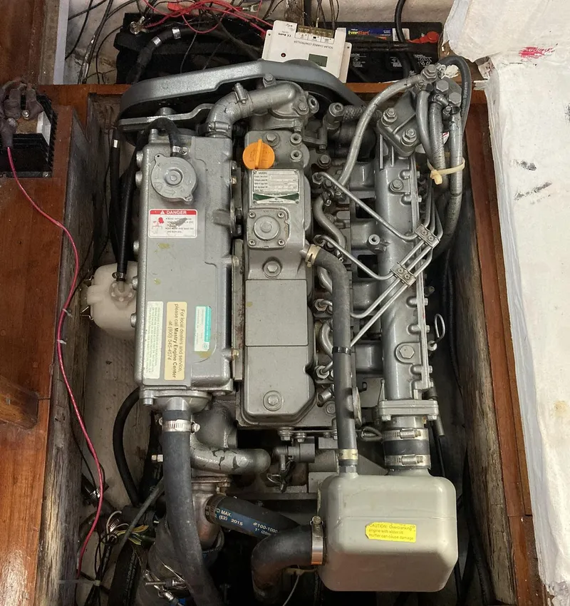 Slide: The Image of Engine compartment of a 1983 Durbeck 38 sailboat, showcasing mechanical components and wiring. - 16