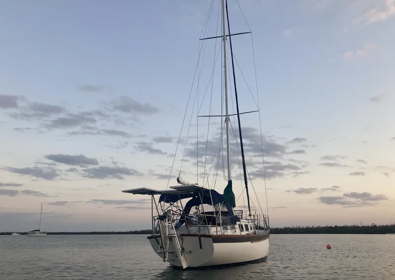 Slide: The Image of Overhead view of a 1983 Durbeck 38 sailboat with solar panels docked by the water. - 2