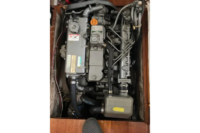 Slide: The Image of 1983 Durbeck 38 sailboat stern with stainless steel fittings reflected in calm water. - 20