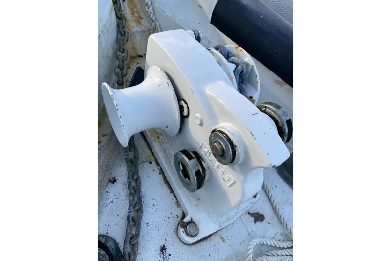 Slide: The Image of 1983 Durbeck 38 sailboat docked, surrounded by greenery and clear blue sky. - 22