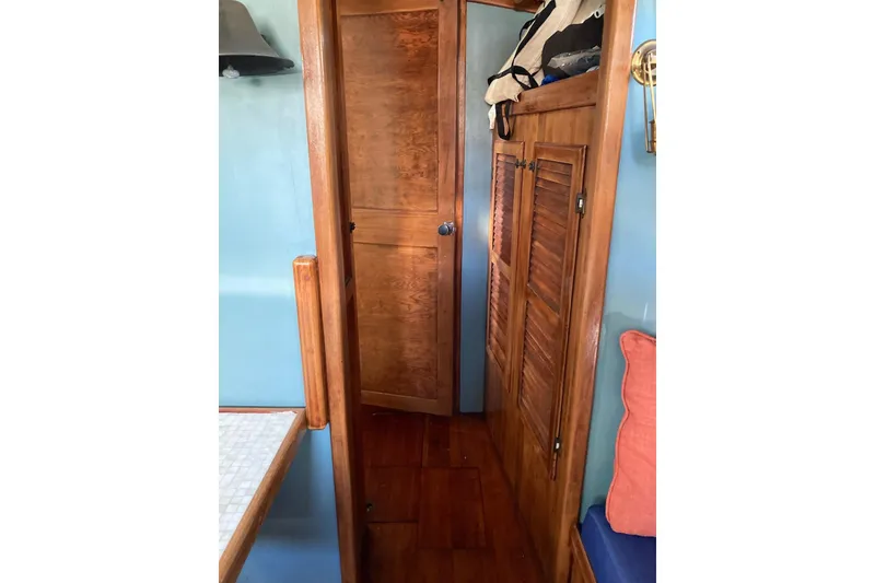 Slide: The Image of Interior of 1983 Durbeck 38 sailboat with wooden doors and blue walls. - 27