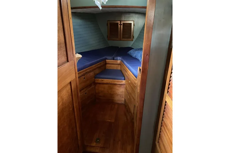Slide: The Image of Cozy cabin interior of 1983 Durbeck 38 sailboat with wooden finish and blue cushions. - 28