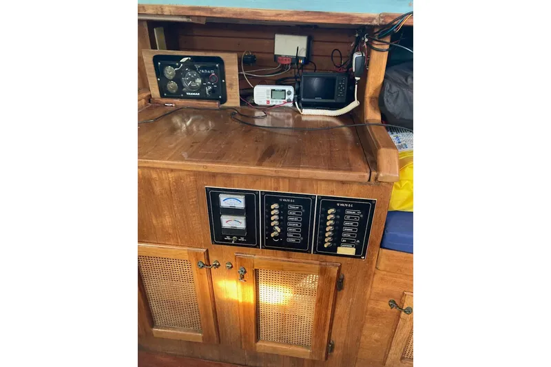 Slide: The Image of Electrical control panel on a 1983 Durbeck 38 boat with wooden cabinetry. - 29
