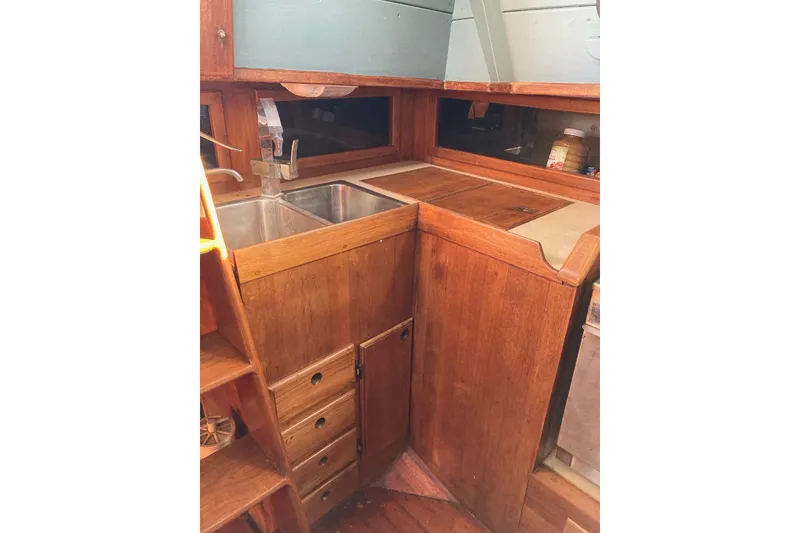 Slide: The Image of 1983 Durbeck 38 yacht interior with wooden cabinetry and stainless steel sink. - 32