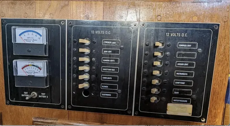 Slide: The Image of Interior of a 1983 Durbeck 38 sailboat with blue seating and wooden accents. - 6