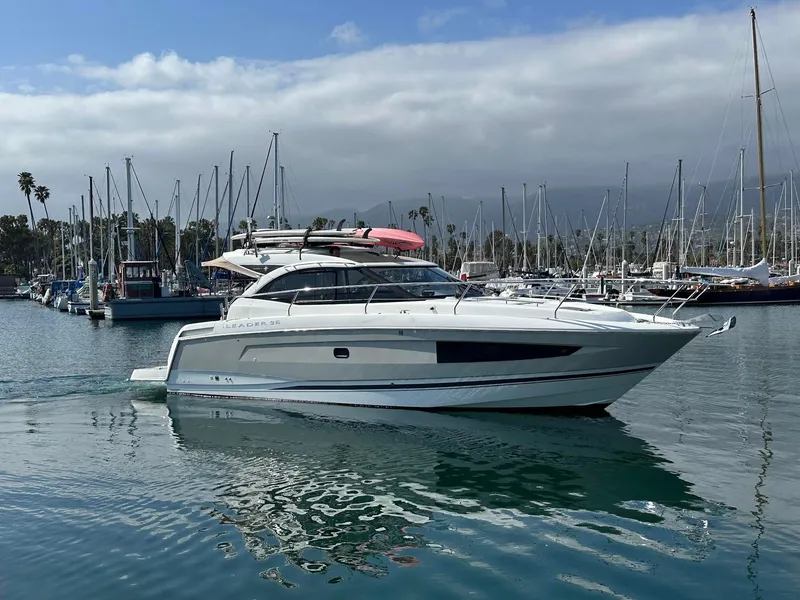 The Image of 2016 Jeanneau Leader 36 yacht in a marina with sailboats and cloudy sky. - 0