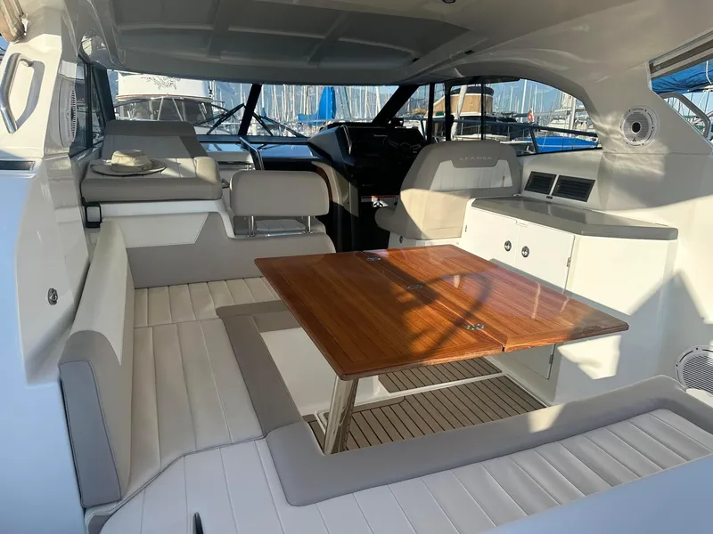 Slide: The Image of Interior of 2016 Jeanneau Leader 36 yacht with seating and wooden table. - 11
