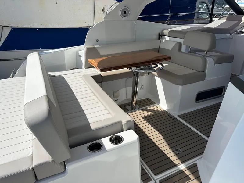 Slide: The Image of 2016 Jeanneau Leader 36 yacht interior with seating and wooden table. - 14