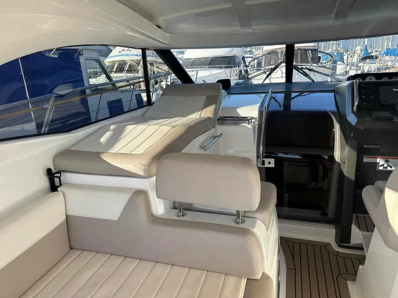 Slide: The Image of Interior of 2016 Jeanneau Leader 36 yacht with beige seating and helm station. - 15