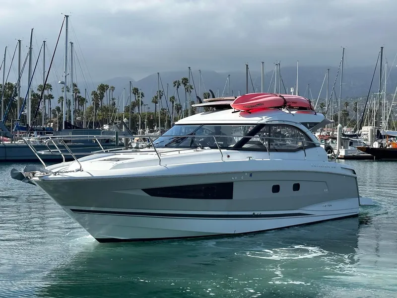 Slide: The Image of 2016 Jeanneau Leader 36 yacht docked in a marina with sailboats in the background. - 2