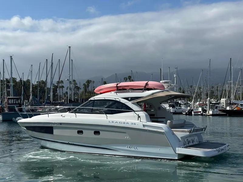 Slide: The Image of 2016 Jeanneau Leader 36 yacht in marina, overcast sky, pink kayak on top. - 5