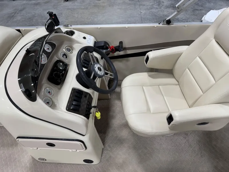 Slide: The Image of Captain's seat and helm of 2012 PlayCraft 2700 Extreme boat, featuring modern controls and gauges. - 10