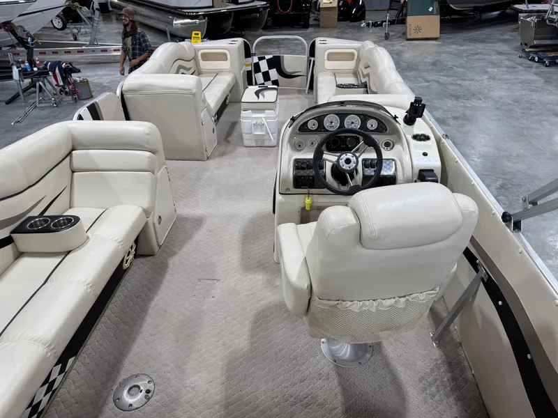 Slide: The Image of Interior of 2012 PlayCraft 2700 Extreme pontoon boat with plush seating and steering console. - 11
