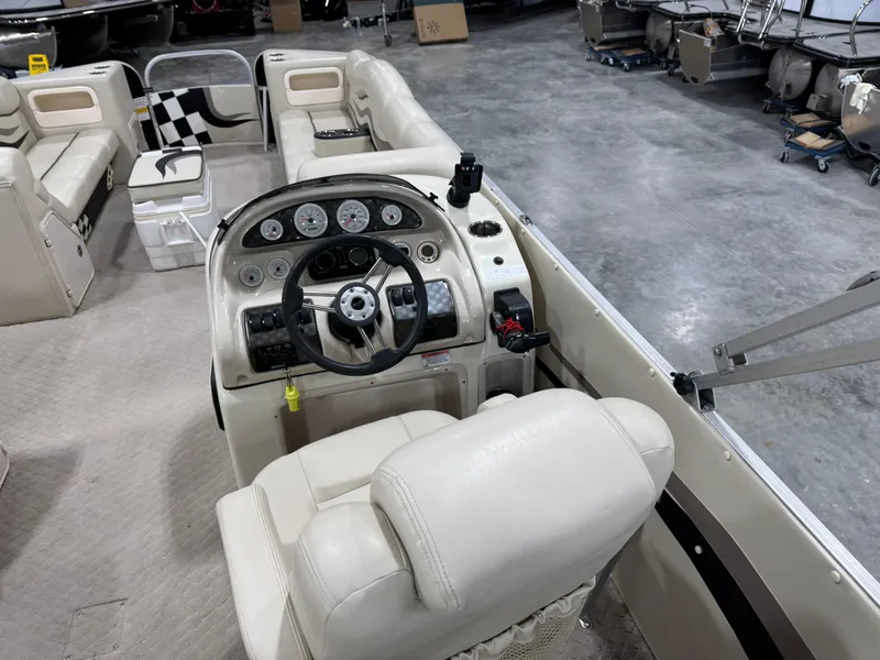 Slide: The Image of Interior of 2012 PlayCraft 2700 Extreme boat with steering console and seating. - 12