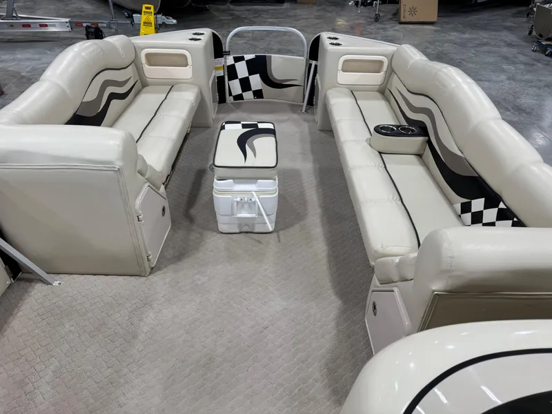 Slide: The Image of Interior of a 2012 PlayCraft 2700 Extreme pontoon boat with beige seating and checkered accents. - 13