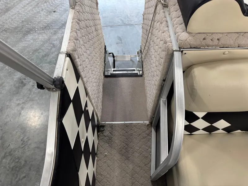 Slide: The Image of Interior view of a 2012 PlayCraft 2700 Extreme boat with checkered design accents. - 14