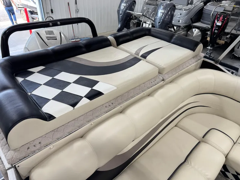 Slide: The Image of 2012 PlayCraft 2700 Extreme boat interior with checkered and striped upholstery design. - 15