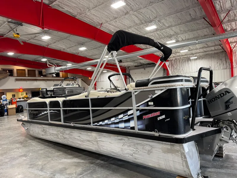 Slide: The Image of 2012 PlayCraft 2700 Extreme pontoon boat in a spacious indoor showroom. - 3