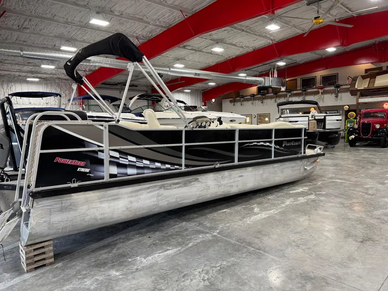 Slide: The Image of 2012 PlayCraft 2700 Extreme pontoon boat in a spacious indoor showroom. - 4