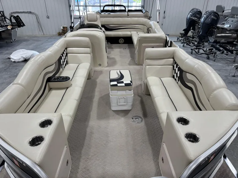 Slide: The Image of Interior of a 2012 PlayCraft 2700 Extreme boat with beige seating and cup holders. - 7