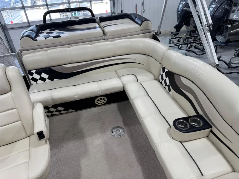 Slide: The Image of Interior of 2012 PlayCraft 2700 Extreme boat with beige seating and checkered design. - 9