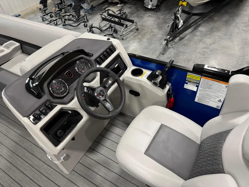 Slide: The Image of 2023 Sweetwater 2286 boat interior with steering wheel and dashboard controls. - 10