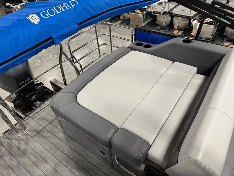 Slide: The Image of 2023 Sweetwater 2286 boat interior with gray seating and Godfrey canopy. - 12