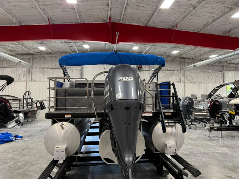 Slide: The Image of 2023 Sweetwater 2286 pontoon boat with 200 HP engine in a showroom. - 5