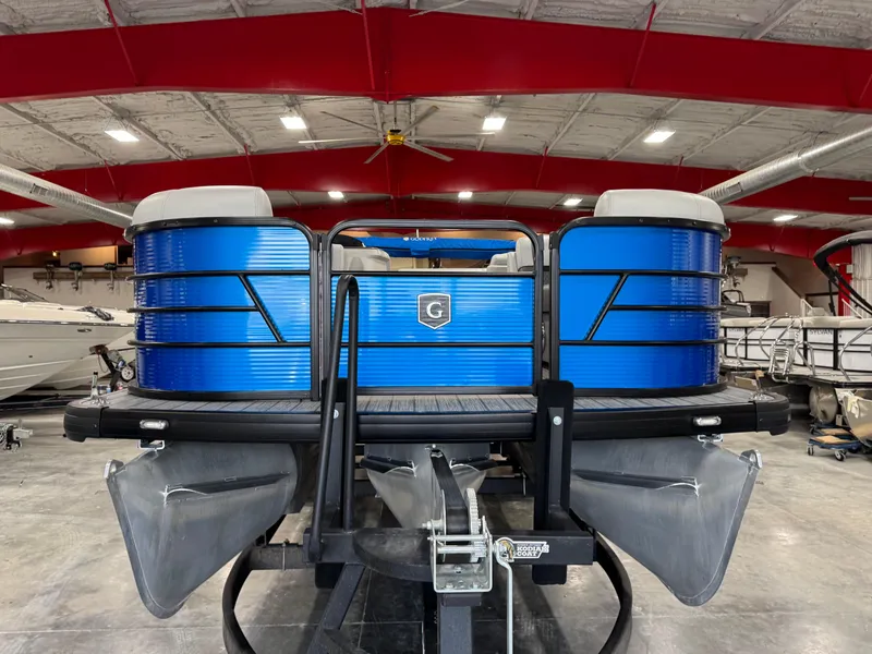 Slide: The Image of 2023 Sweetwater 2286 pontoon boat in a showroom, featuring a sleek blue design. - 6