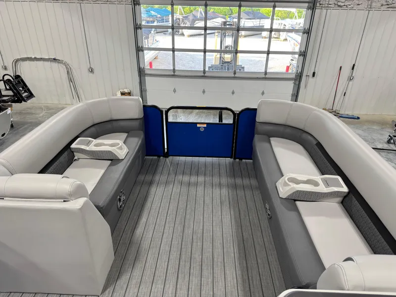 Slide: The Image of 2023 Sweetwater 2286 pontoon boat interior with gray seating and cup holders. - 8