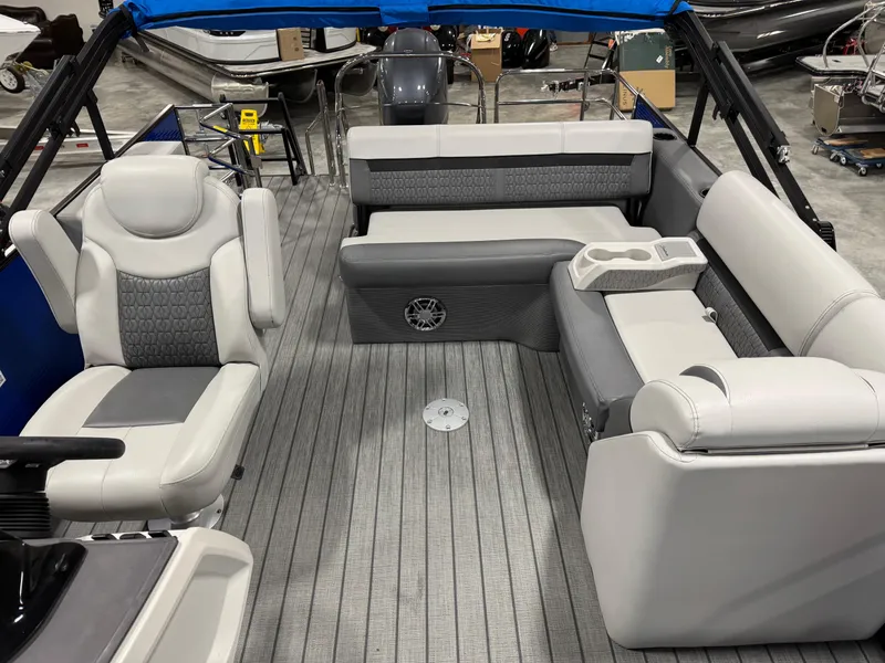 Slide: The Image of 2023 Sweetwater 2286 boat interior with gray seating and flooring, featuring a modern design. - 9