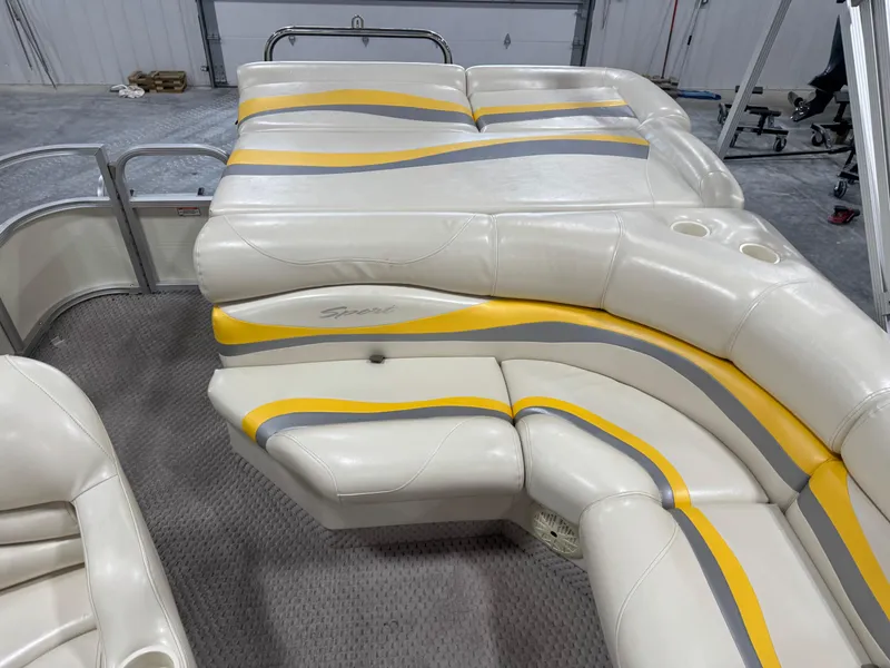Slide: The Image of 2005 Bennington 2275 RL boat interior with white, yellow, and gray cushioned seating. - 12