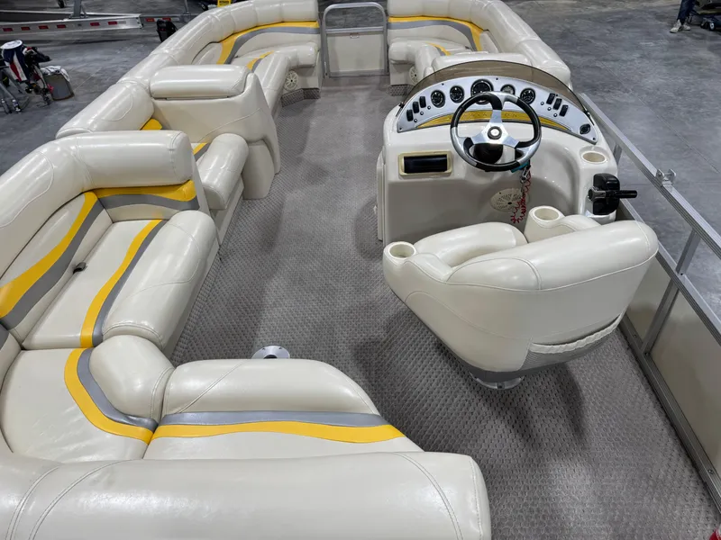 Slide: The Image of 2005 Bennington 2275 RL pontoon boat interior with plush seating and steering console. - 15