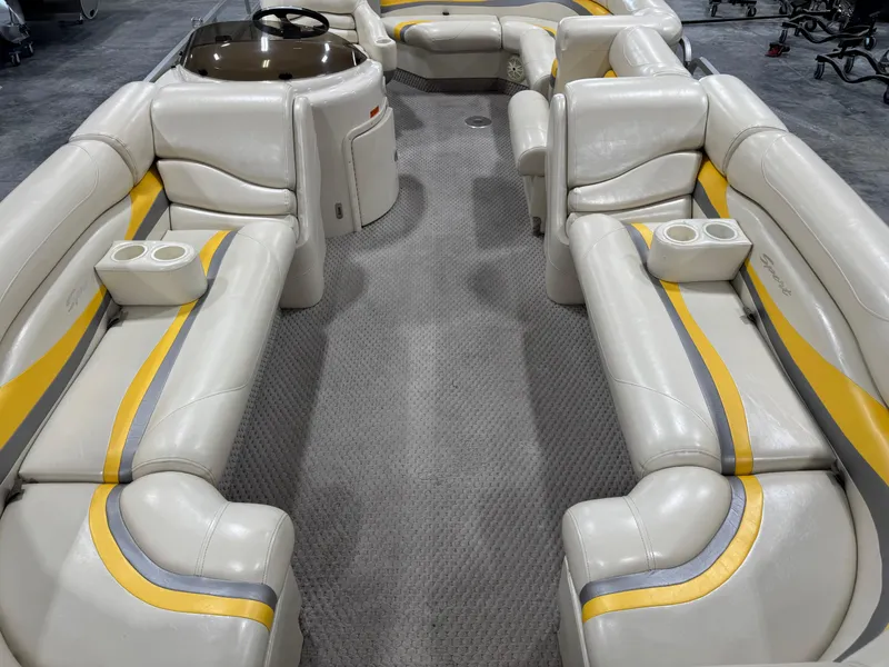 Slide: The Image of 2005 Bennington 2275 RL pontoon boat interior with beige and yellow seating. - 8