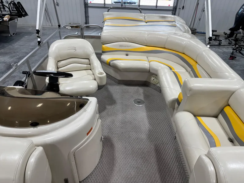 Slide: The Image of 2005 Bennington 2275 RL pontoon boat interior with beige and yellow seating. - 9