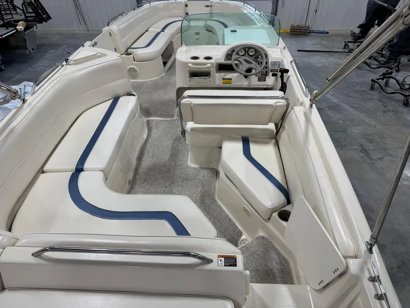 Slide: The Image of 2001 Bayliner 26 Rendevous boat interior with white and blue seating, steering console. - 10