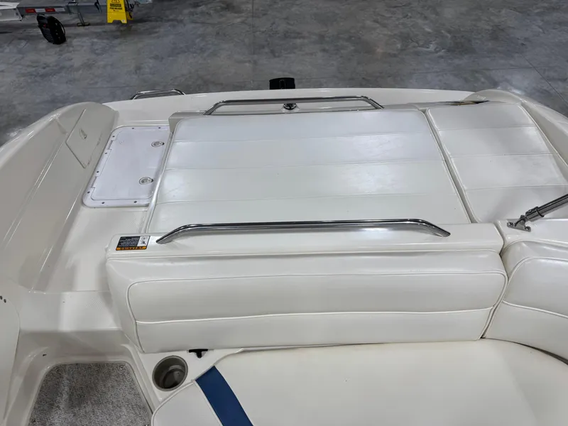 Slide: The Image of 2001 Bayliner 26 Rendevous boat interior with white seating and metal railings. - 11