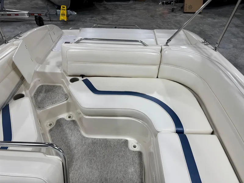 Slide: The Image of 2001 Bayliner 26 Rendevous boat interior with white and blue seating arrangement. - 12