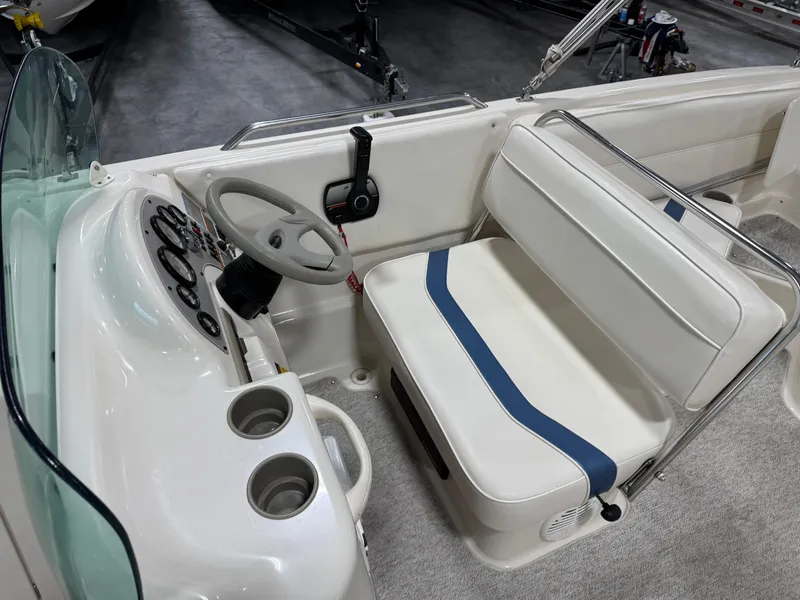 Slide: The Image of 2001 Bayliner 26 Rendevous boat interior with steering wheel and seating area. - 13
