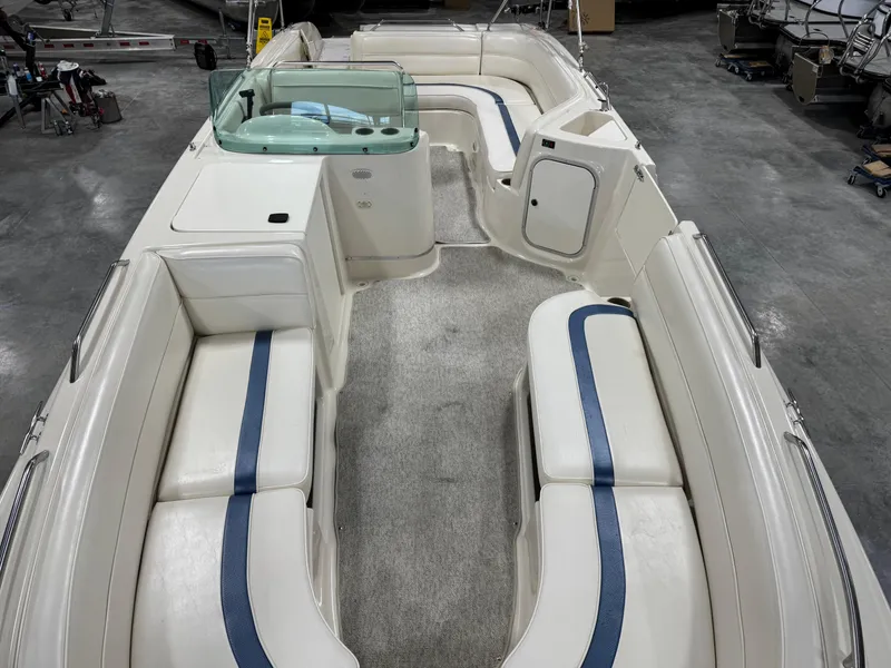 Slide: The Image of 2001 Bayliner 26 Rendevous boat interior with white seating and blue accents. - 15