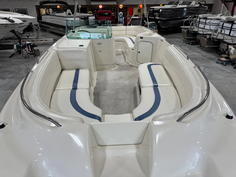 Slide: The Image of 2001 Bayliner 26 Rendevous boat interior with spacious seating in a showroom. - 16