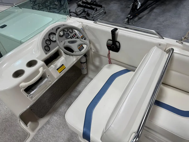Slide: The Image of 2001 Bayliner 26 Rendevous boat interior with steering wheel and seating area. - 9