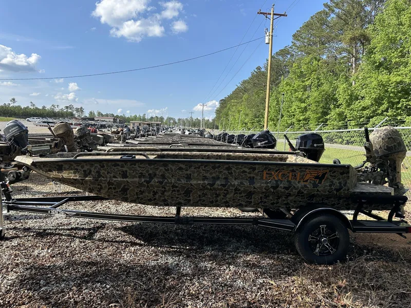 Slide: The Image of 2025 Excel Viper F4 1751 boat with camouflage design, parked outdoors on a trailer. - 1