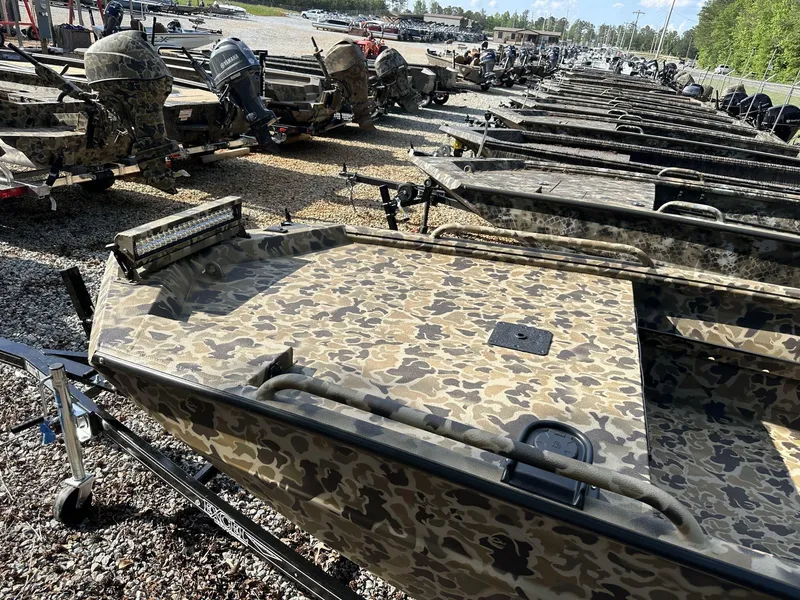 Slide: The Image of Row of camouflaged Excel Viper F4 1751 boats, 2025 model, parked outdoors. - 2