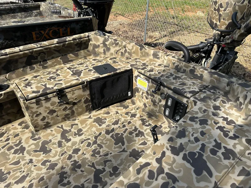 Slide: The Image of Camouflage interior of 2025 Excel Viper F4 1751 boat with control panel and storage compartments. - 4