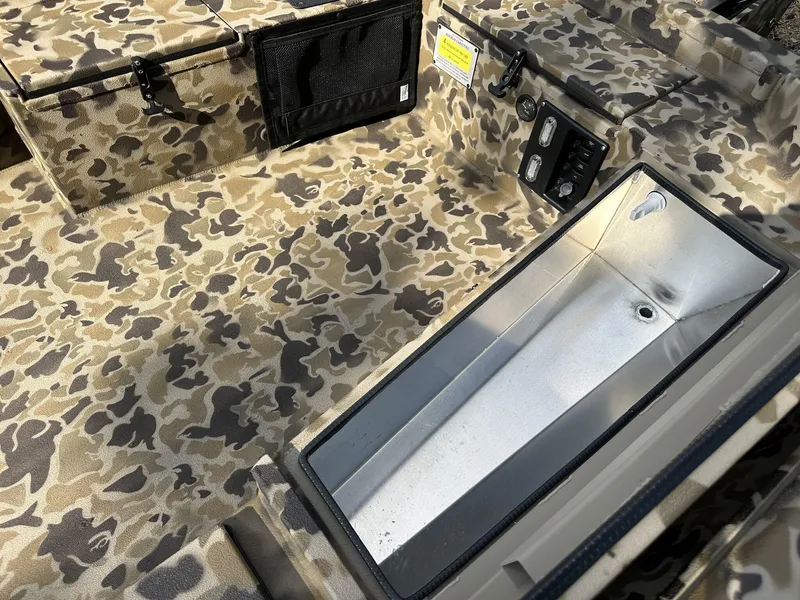 Slide: The Image of Camouflage interior of 2025 Excel Viper F4 1751 boat with storage compartments. - 5