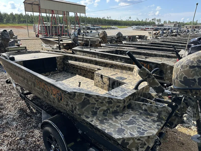 Slide: The Image of 2025 Excel Viper F4 1751 boat with camouflage design in a boatyard. - 11