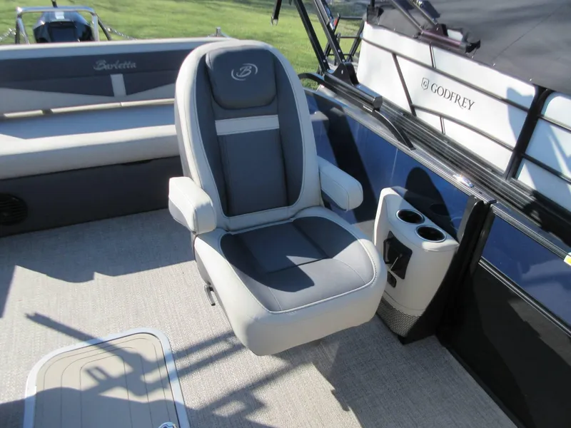 Slide: The Image of 2022 Barletta Cabrio 22UC boat interior with comfortable seating and cup holders. - 5