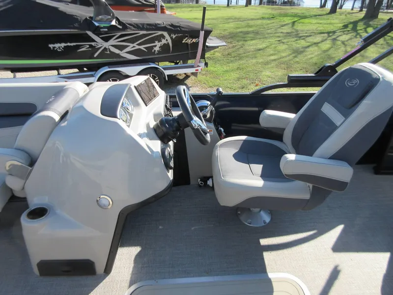Slide: The Image of 2022 Barletta Cabrio 22UC boat interior with steering console and captain's chair. - 6