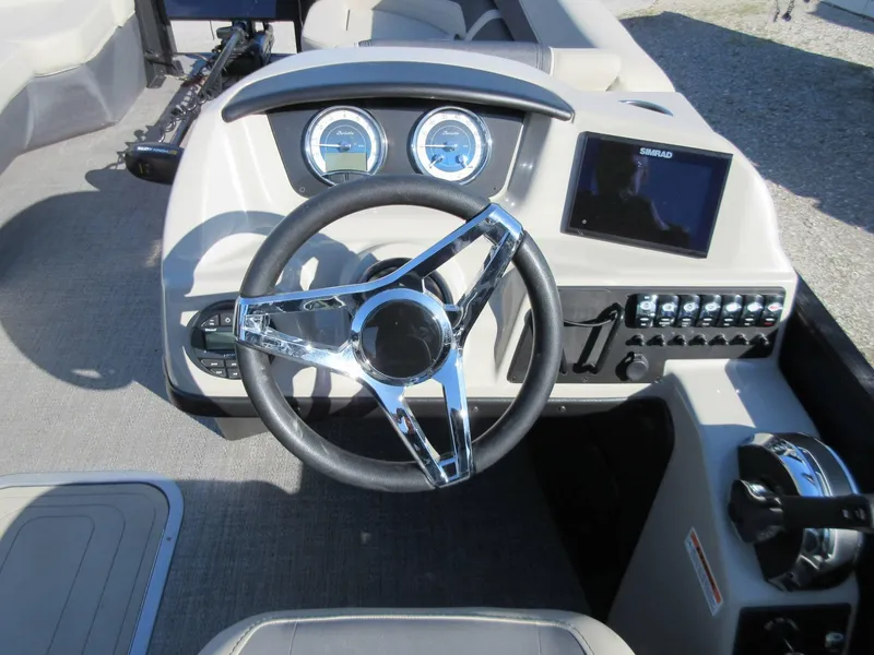 Slide: The Image of 2022 Barletta Cabrio 22UC boat dashboard with steering wheel and control panel. - 7
